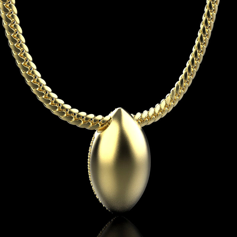 Gold football necklace pendant on a black background