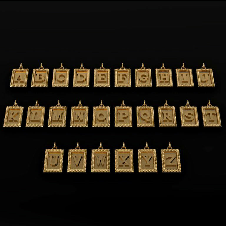 Set of gold letter pendants on a black background
